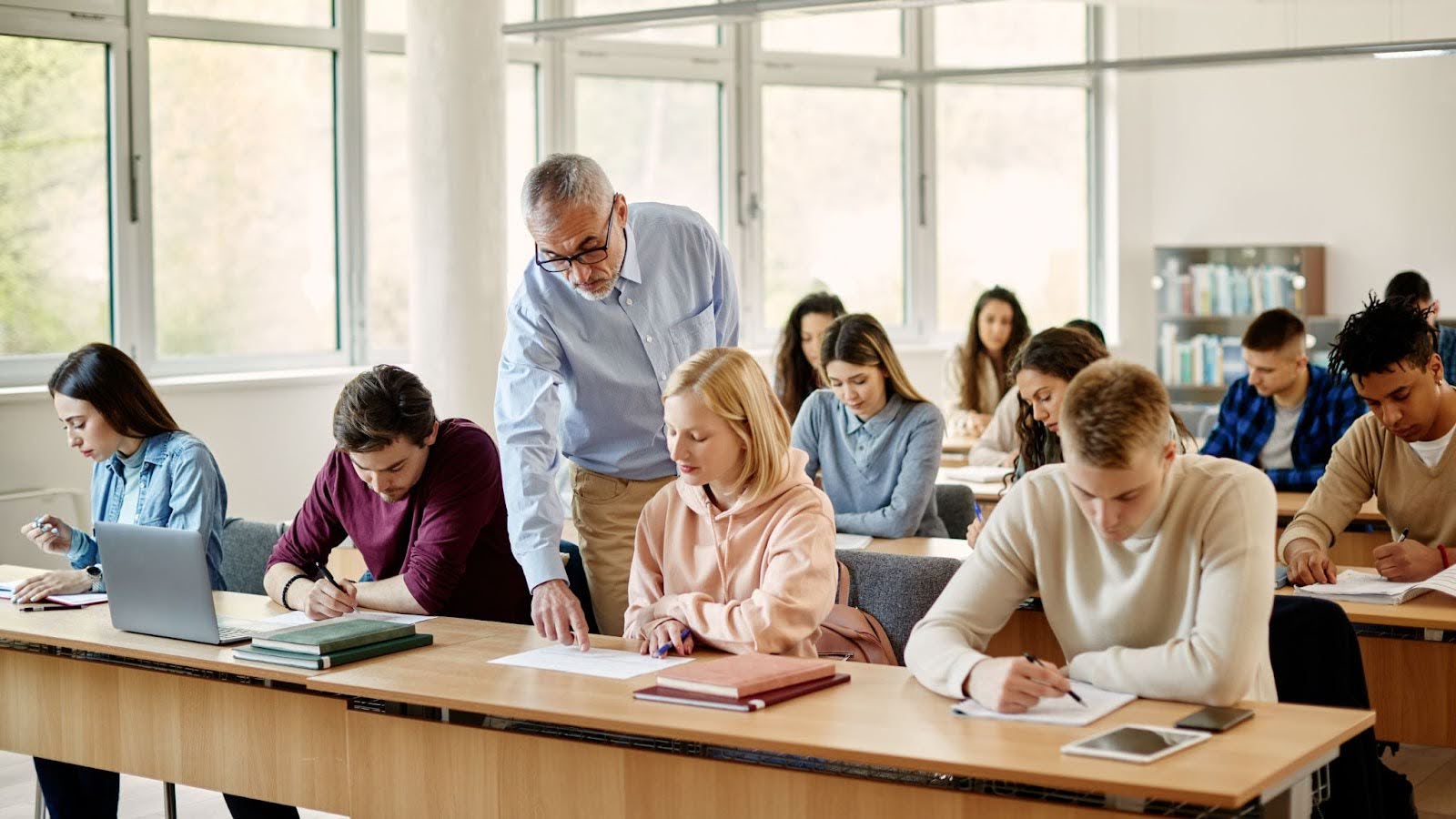 A professor assisting a student during class, showing accessible academic support.